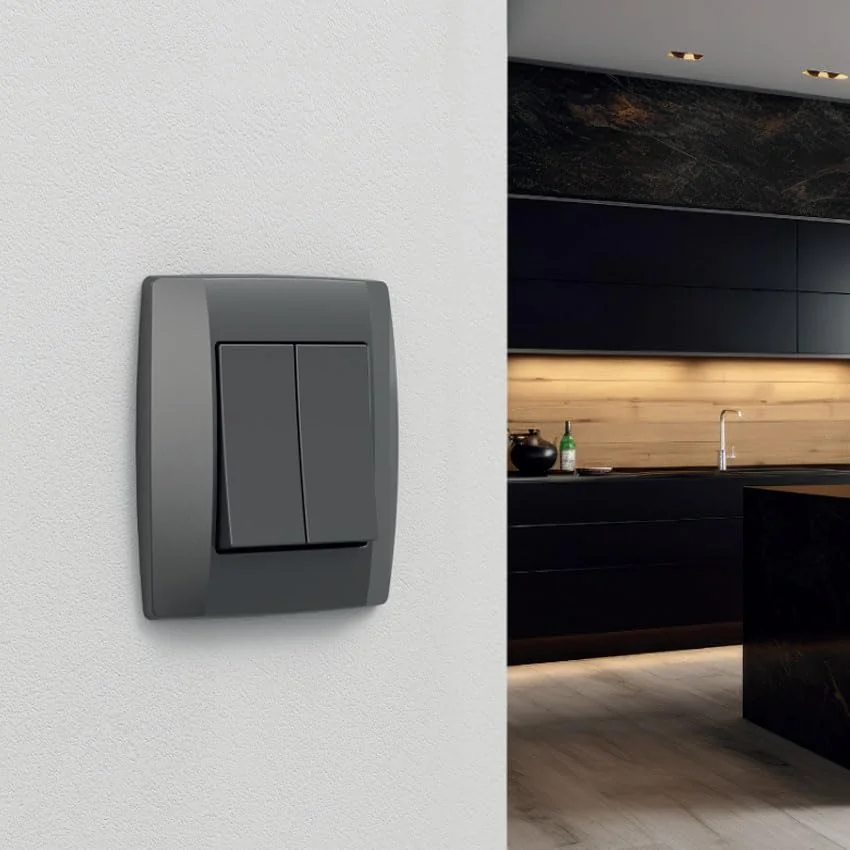 doble conmutador de superficie grafito, serie mural, ideal para controlar iluminación en hogares y oficinas.